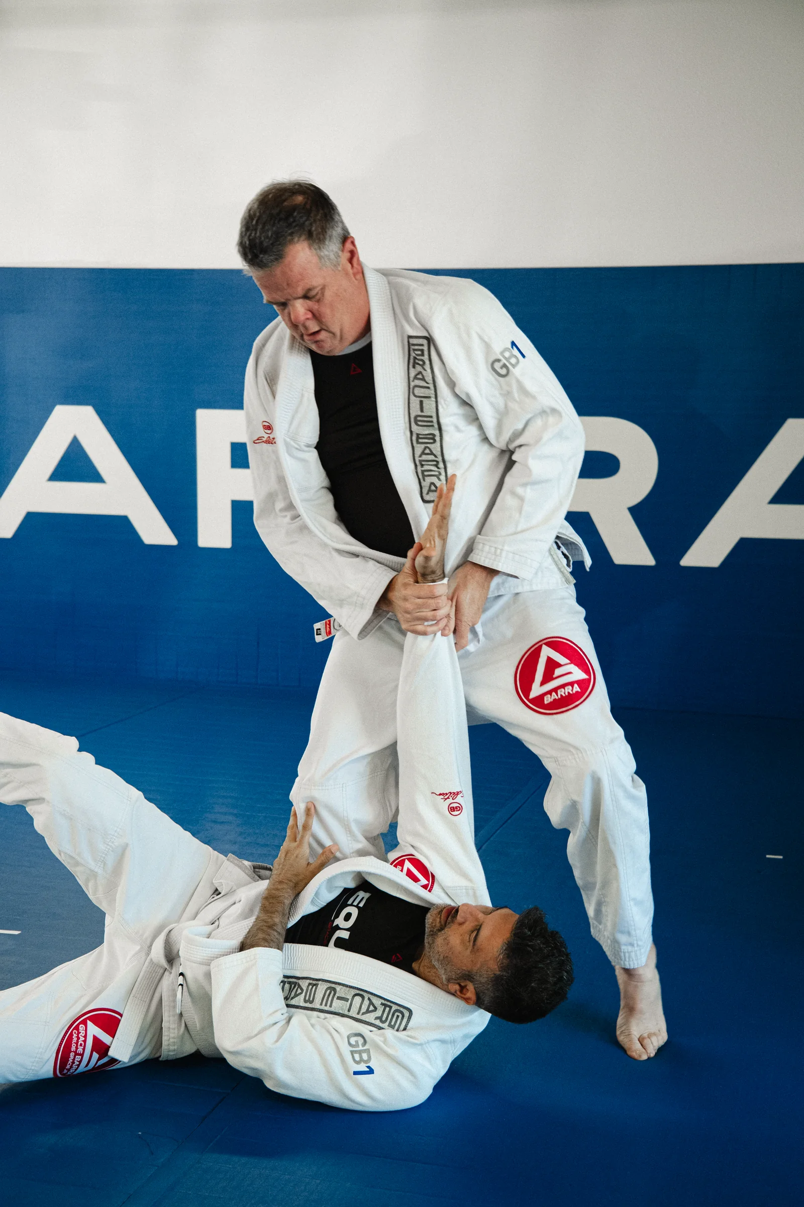 Two GB1 white belt students practicing Jiu-Jitsu at Gracie Barra Aliso Viejo